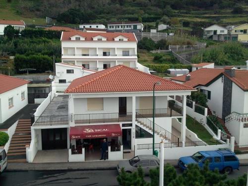 a large white building with a red roof at Residência Livramento in Velas