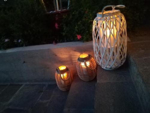 a group of three vases sitting on a sidewalk at Residence MareVerde in Senigallia