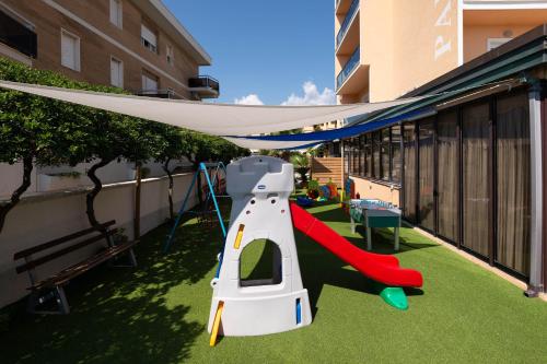a play area with a slide on a balcony at Hotel Paradiso in Grottammare