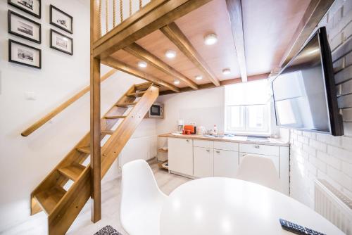a kitchen with a staircase in a tiny house at Revelton Studios Karlovy Vary in Karlovy Vary