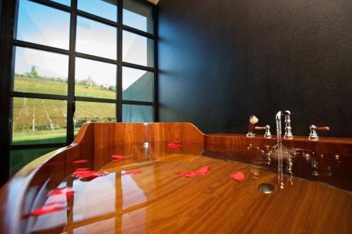 a bathroom with a wooden table with blood on the floor at Réva Resort in Monforte dʼAlba