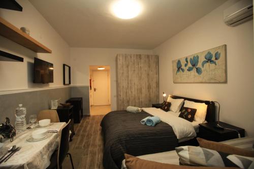 a hotel room with a bed and a table at Elena Apartments in Tel Aviv