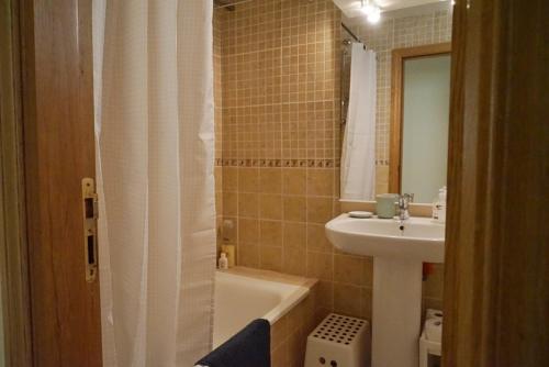 a bathroom with a sink and a toilet and a tub at Balcón del Mar - Playa San Juan in Guía de Isora