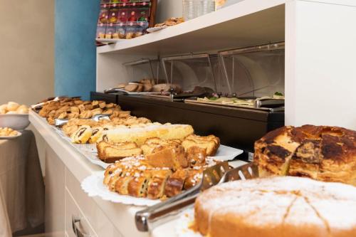 a buffet line with various types of bread and pastries at Hotel Paradiso in Grottammare