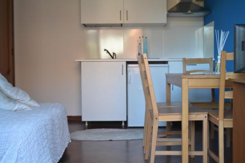 a kitchen with a table and chairs and a kitchen with a table and a table at Residence MareVerde in Senigallia