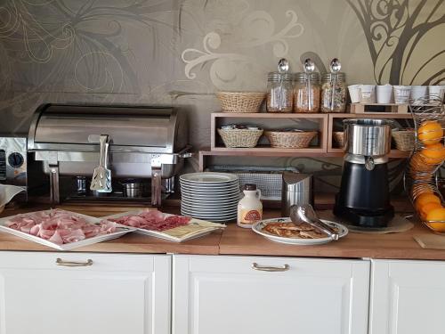 a kitchen counter with some food on a counter top at Hotel Beppe in Rimini