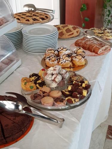 a table topped with different types of pastries and desserts at Hotel Beppe in Rimini