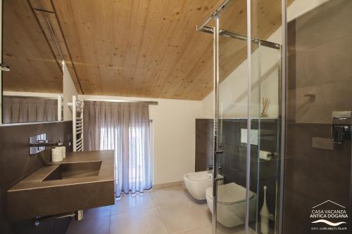 a bathroom with a shower and a sink and a toilet at Antica Dogana in Pisogne
