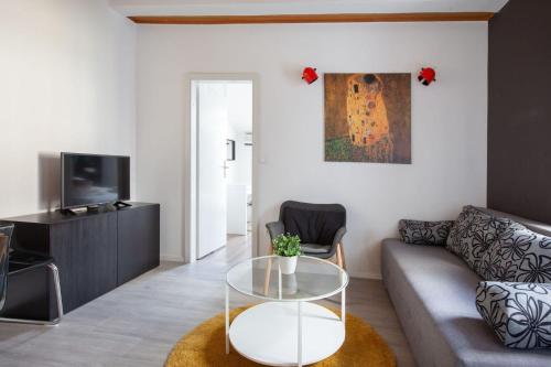 a living room with a couch and a glass table at Apartments Agneza Tucepi in Tučepi