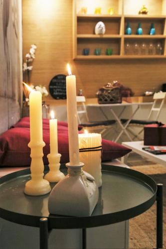 two candles on a table in a living room at Artistic Charming House in Caserta