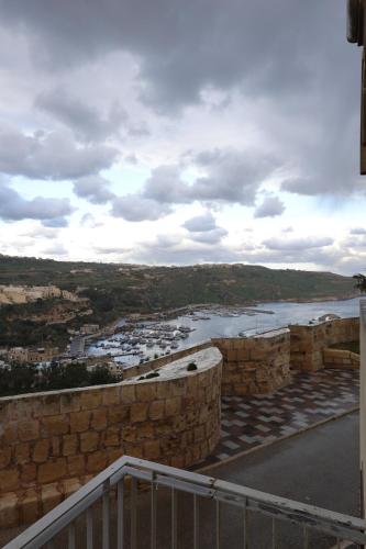 a view of a body of water from a building at Harbour Views Duplex Maisonette with Jacuzzi Hot tub in Mġarr
