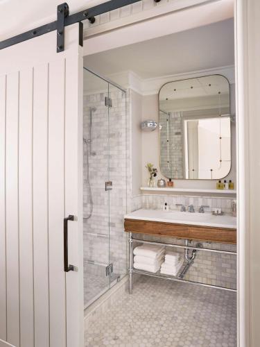 a bathroom with a shower and a sink at The Beekman, A Thompson Hotel, by Hyatt in New York