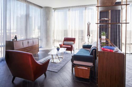 a living room with a couch and chairs in a building at Thompson Nashville, by Hyatt in Nashville