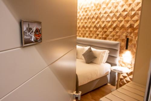 a small room with a bed and a mirror at Lifestyle Room Binario Zero in Tirano