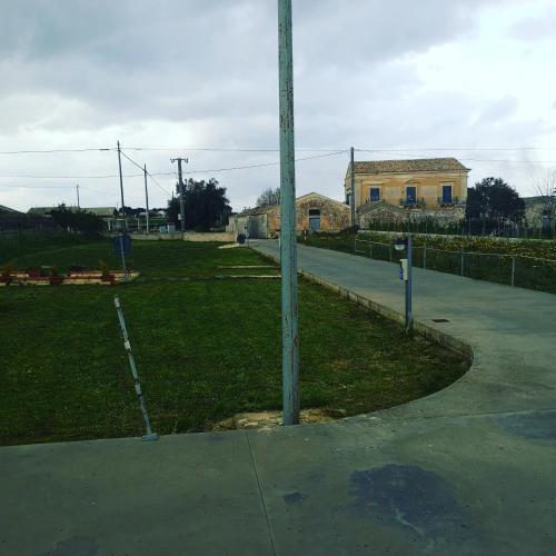 a pole on the side of a street with a building at Villa Rosa in Modica