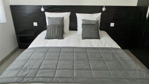 1 cama grande con 2 almohadas encima en DOMAINE VILONAPA - villa Figuier et villa Murier, en Saint Alban Auriolles