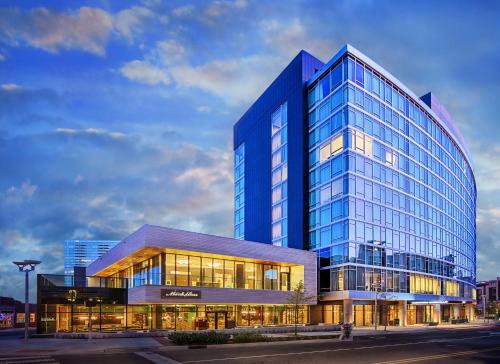 a large blue glass building with a lot of windows at Thompson Nashville, part of Hyatt in Nashville