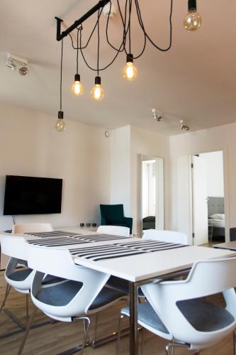 a dining room with a white table and chairs at Silver Apartments in Wrocław