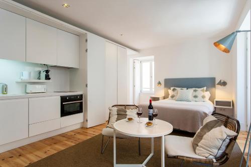 a bedroom with a bed and a table and chairs at Lisbon Five Stars Apartments Combro 77 in Lisbon