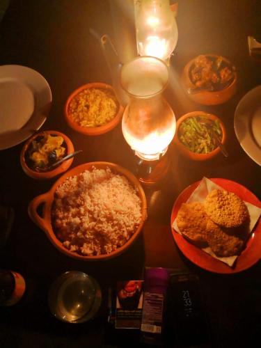 a table with different dishes of food on it at Moksha eco villa Ella in Ella