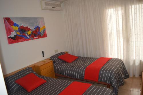 a bedroom with two beds and a window at Apartamento Completo 200m Playa in Roses