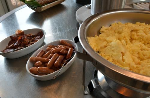 a counter with three bowls of potato chips and a pot of food at Skærbæk Holiday Center in Skærbæk