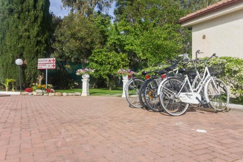 a group of bikes parked on a brick road at Le Villette di Villa Paola in Loano