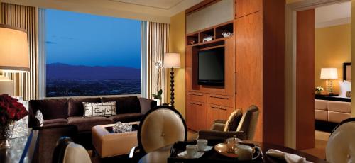 a living room with a couch and a large window at Trump International Hotel Las Vegas in Las Vegas