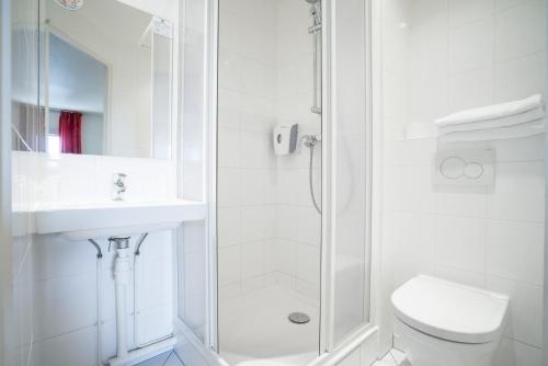 a bathroom with a shower and a toilet and a sink at Premiere Classe Rungis - Orly in Rungis