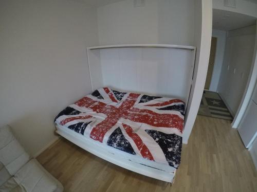 a bed in a room with an american flag blanket at Soolo 7th floor lake view in Jyväskylä