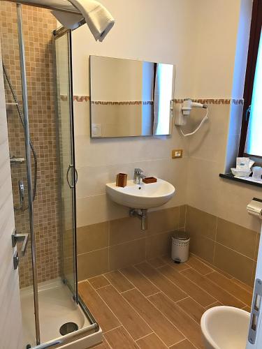 a bathroom with a sink and a shower at Antiche Terre Hotel & Relax in Pignone