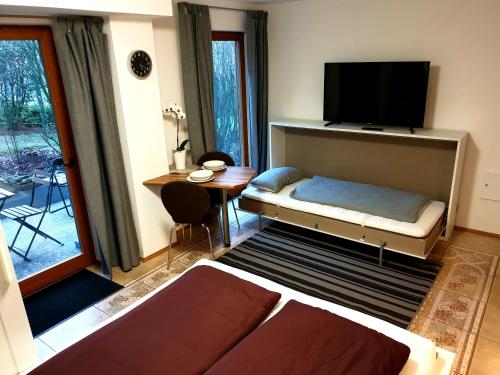 a bedroom with a bed and a flat screen tv at Wohlfühl-Apartment Bad Kissingen II in Bad Kissingen