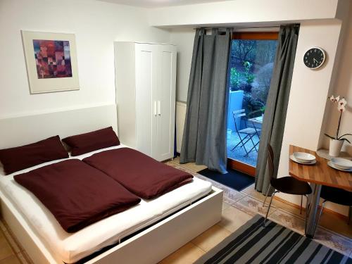 - une chambre avec un lit, un bureau et une fenêtre dans l'établissement Wohlfühl-Apartment Bad Kissingen II, à Bad Kissingen