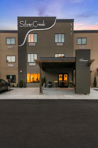 a building with a car parked in front of it at Silver Creek Hotel in Hailey