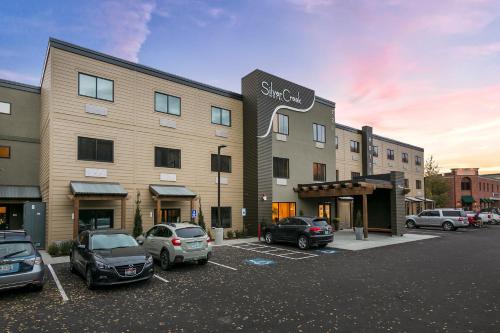 a building with cars parked in a parking lot at Silver Creek Hotel in Hailey