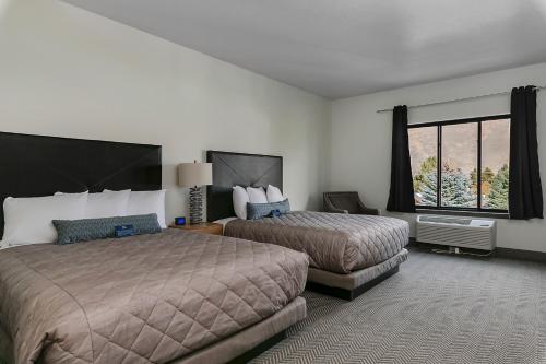 a hotel room with two beds and a window at Silver Creek Hotel in Hailey