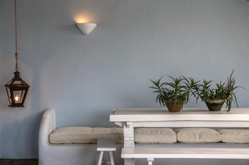 a living room with a white table and a couch at Onar Hotel & Suites in Tinos Town