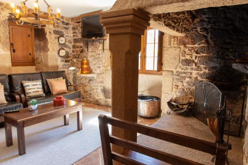 a living room with a couch and a table at Casa Rural as Bentinas in Milladoiro