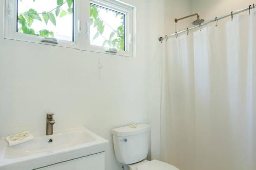 a bathroom with a toilet and a sink and a window at Stay at Mare in San Juan