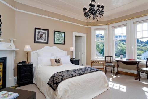a bedroom with a bed and a fireplace at St Leonards Lodge in Dunedin