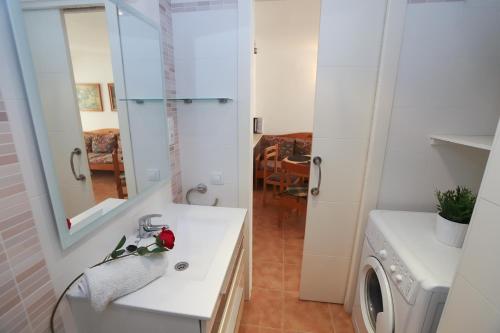 a bathroom with a sink and a washing machine at COSTA DAURADA APARTAMENTS - Colibri Beach in Cambrils