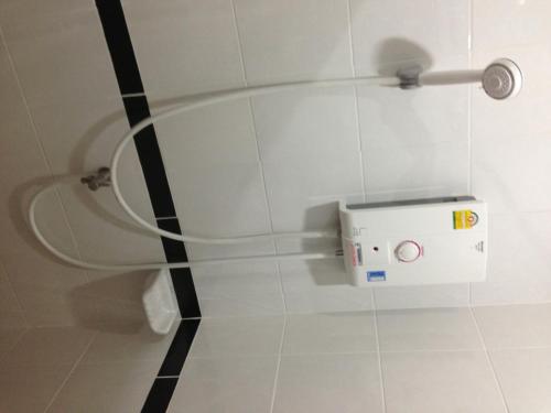 a white shower in a bathroom with a toilet at Kanlaya Park in Mae Nam