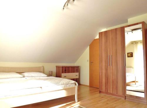 a bedroom with a bed and a large mirror at Vad-Virág Vendégház in Fertőrákos