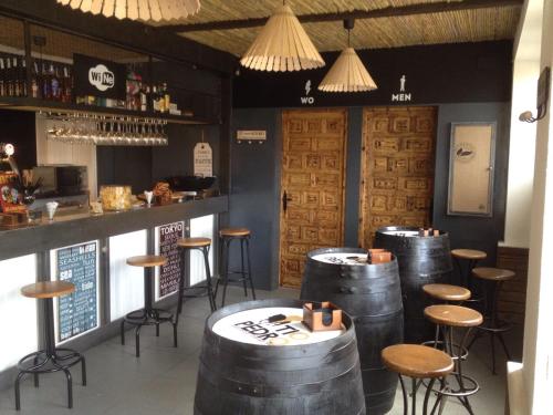 a bar with a bunch of wine barrels in a room at Hotel Rio Piedra in Nuévalos
