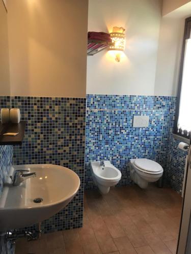 a bathroom with a sink and a toilet at Agriturismo La Vita è Bella in Fabriano