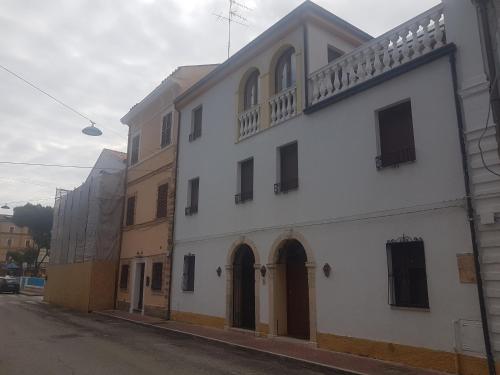 a white building on the side of a street at La Casa Blanca in Grottammare
