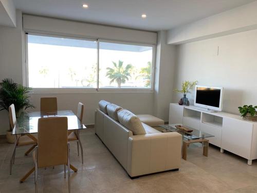 a living room with a couch and a table at Diamond Apartments Puerto De Malaga in Málaga