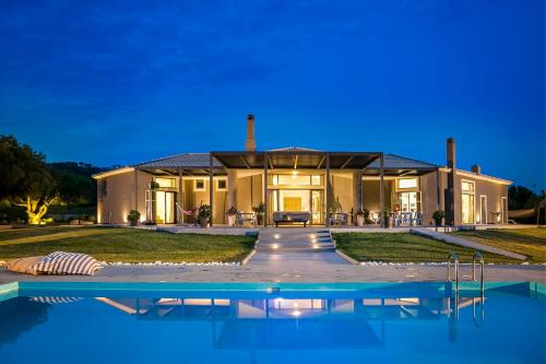 a house with a swimming pool in front of it at Villa Katrin in Svoronata