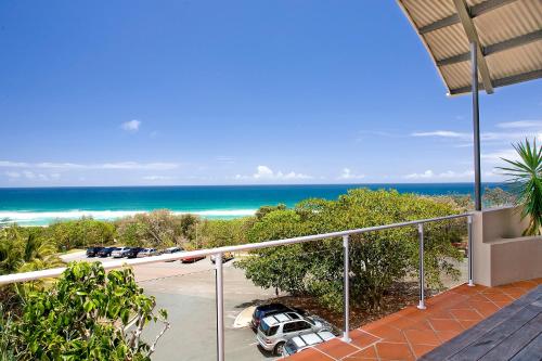 a view of the ocean from the balcony of a house at Aqua Promenade Beachfront Holiday Apartments in Sunrise Beach