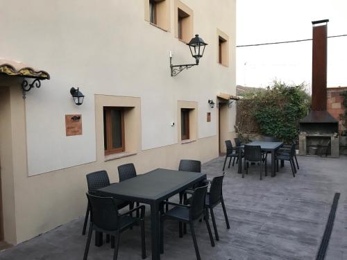 a patio with tables and chairs and a grill at Casa la Barbacana in Barbastro
